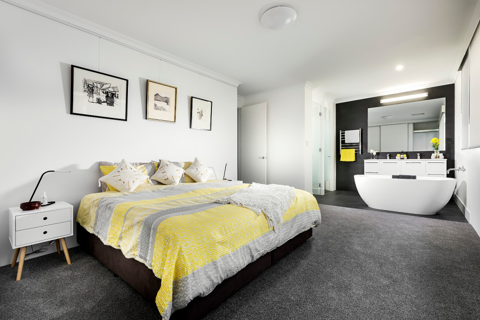 This is an example of a large contemporary bedroom in Perth with white walls, carpet and black floor.