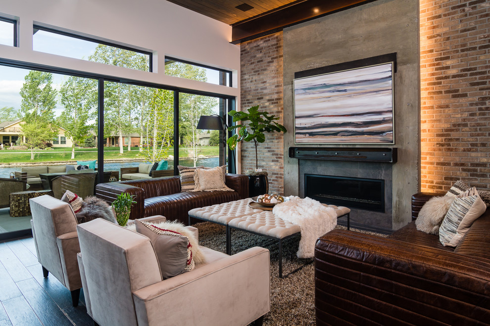Design ideas for a mid-sized industrial open concept family room in Boise with multi-coloured walls, a ribbon fireplace, a concrete fireplace surround, no tv and black floor.