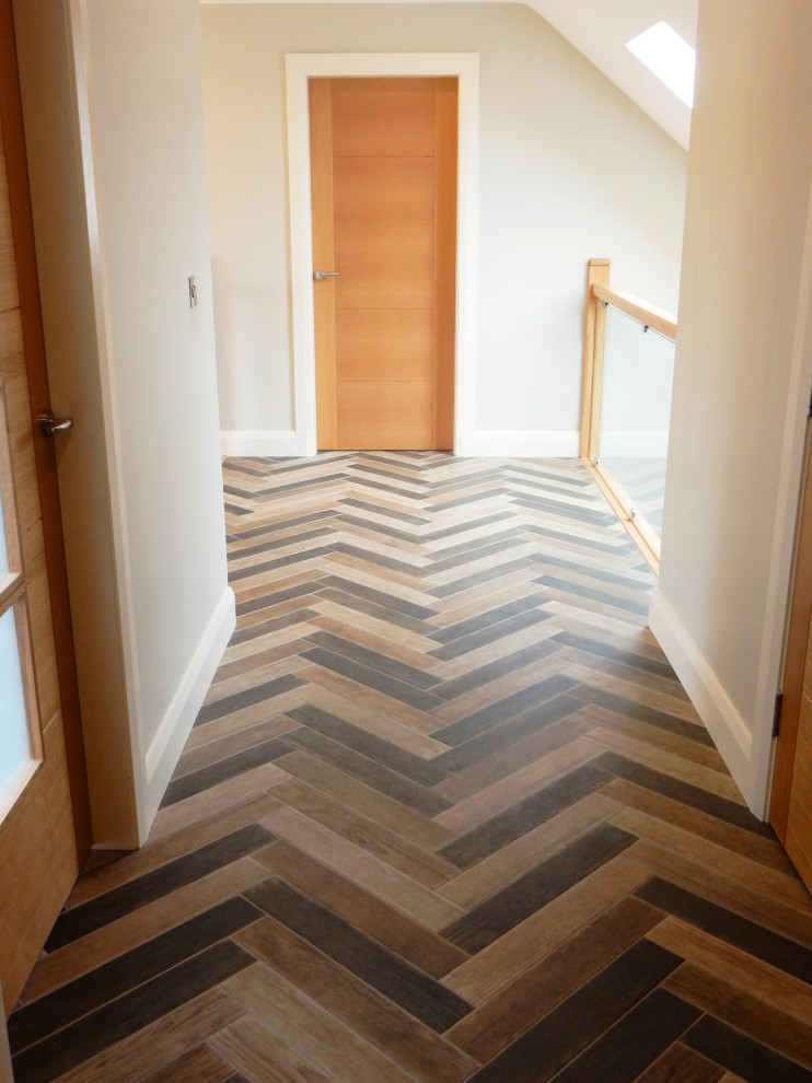This is an example of a mid-sized contemporary hallway in Other with porcelain floors and brown floor.