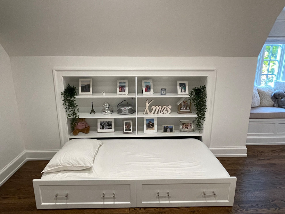 Built in Trundle Bed - Kids' bedroom - bedroom and large modern girl medium tone wood floor, brown floor and vaulted ceiling kids' bedroom idea in New York with white walls