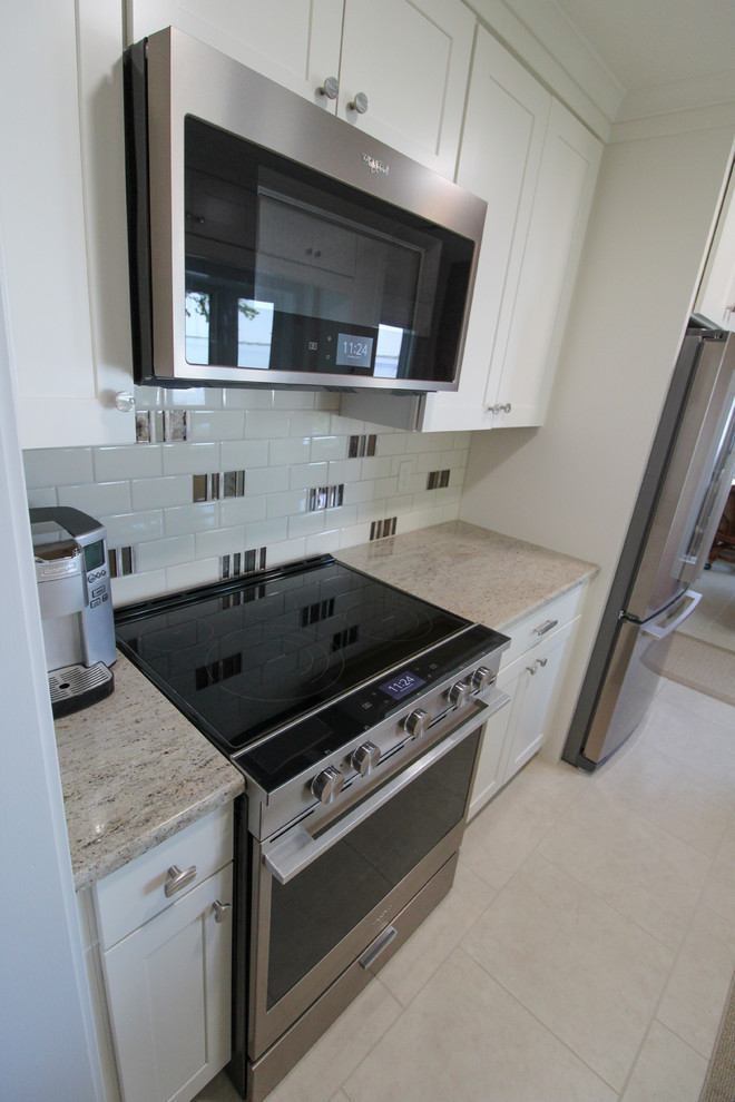 Kitchen - kitchen idea with an undermount sink, shaker cabinets, white cabinets, granite countertops and stainless steel appliances