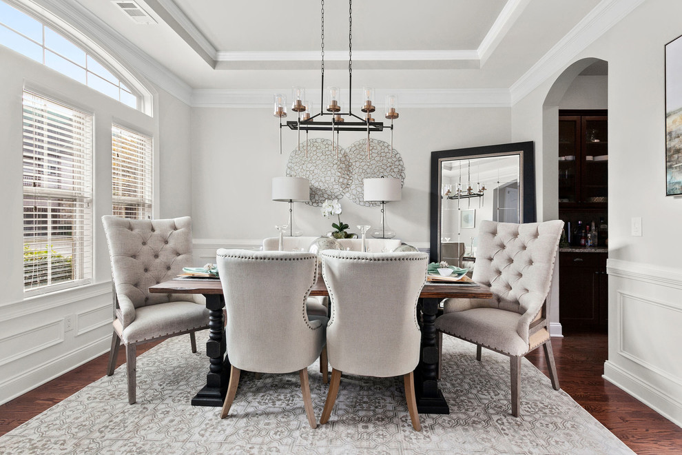 Inspiration for a transitional dark wood floor and brown floor enclosed dining room remodel in Atlanta with gray walls