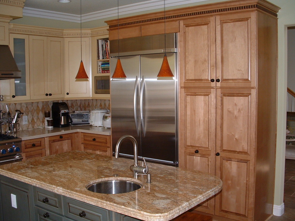 Mid-sized transitional u-shaped travertine floor eat-in kitchen photo in Orange County with a farmhouse sink, shaker cabinets, yellow cabinets, quartz countertops, multicolored backsplash, stone tile backsplash, stainless steel appliances and an island