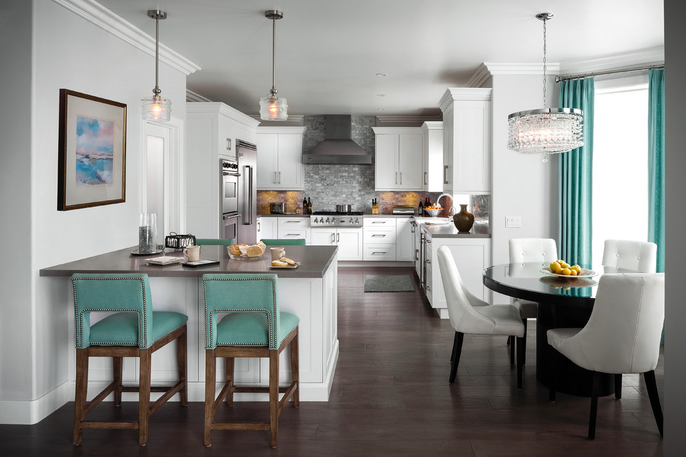 Eat-in kitchen - large transitional u-shaped dark wood floor and brown floor eat-in kitchen idea with a farmhouse sink, shaker cabinets, white cabinets, quartz countertops, gray backsplash, stone tile backsplash, stainless steel appliances, a peninsula and gray countertops