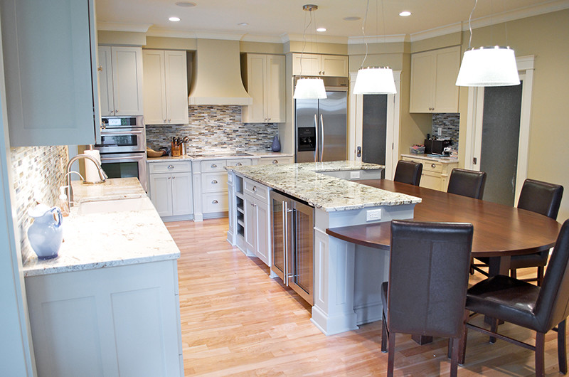 Eat-in kitchen - large transitional l-shaped light wood floor and brown floor eat-in kitchen idea in Houston with an undermount sink, shaker cabinets, white cabinets, granite countertops, multicolored backsplash, matchstick tile backsplash, stainless steel appliances, an island and gray countertops