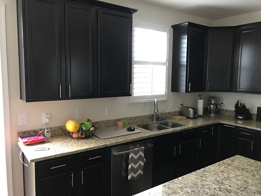 Design ideas for a large contemporary l-shaped kitchen in Baltimore with grey splashback, glass tile splashback, a double-bowl sink, recessed-panel cabinets, black cabinets, granite benchtops and with island.