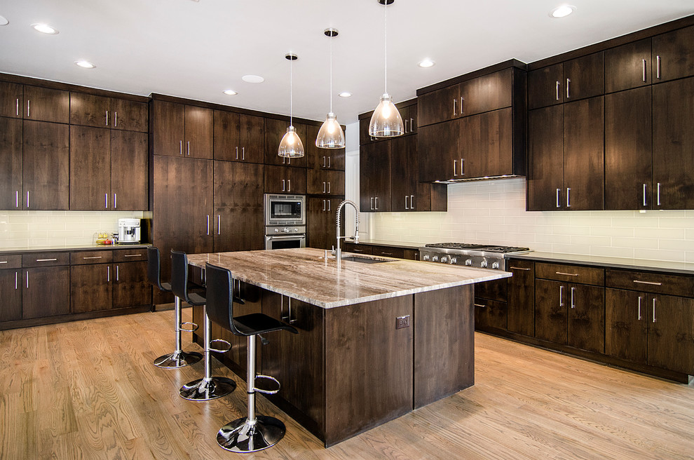 Photo of a large transitional l-shaped open plan kitchen in Dallas with an undermount sink, flat-panel cabinets, dark wood cabinets, quartzite benchtops, beige splashback, glass tile splashback, stainless steel appliances, light hardwood floors and with island.