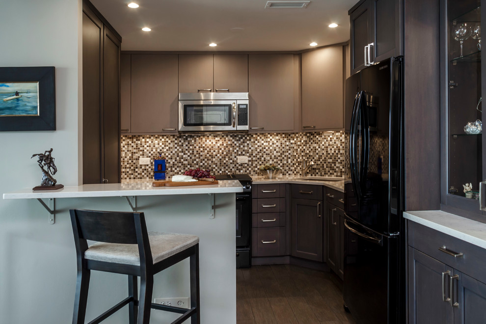 Small transitional dark wood floor enclosed kitchen photo in Chicago with an undermount sink, flat-panel cabinets, brown cabinets, granite countertops, multicolored backsplash, ceramic backsplash, black appliances and no island