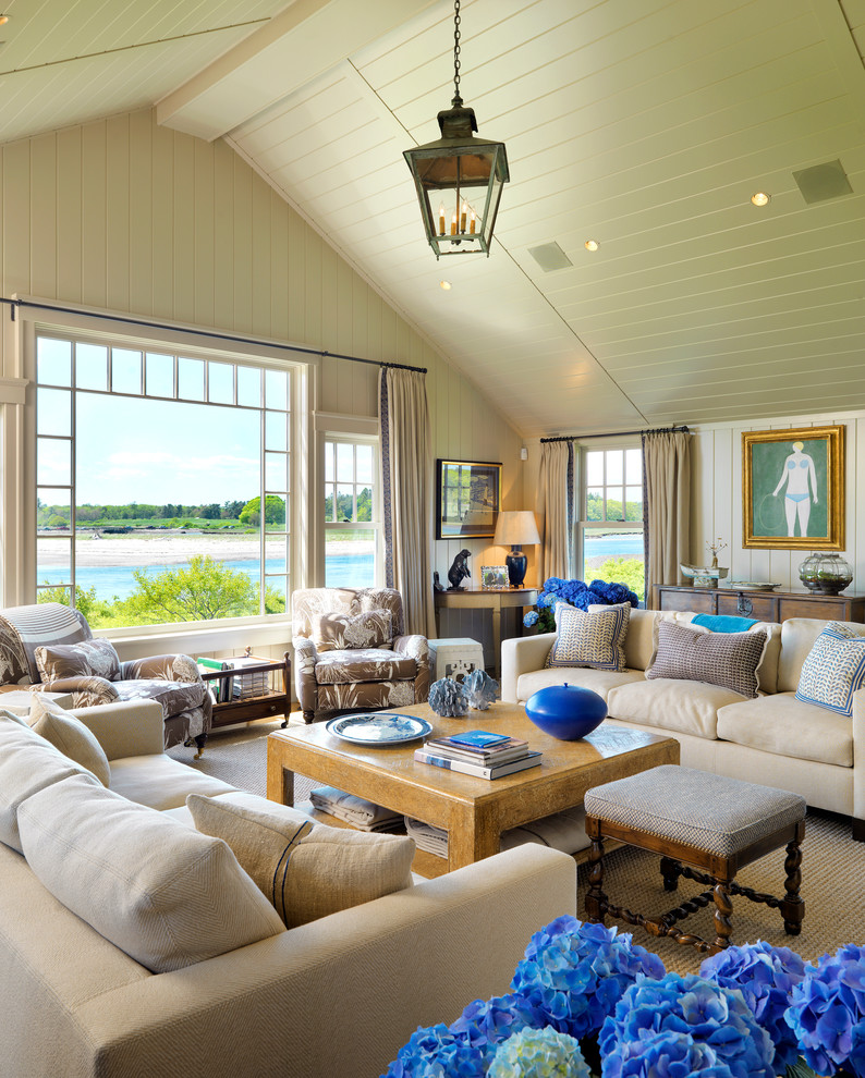 This is an example of a beach style living room in Boston with beige walls.