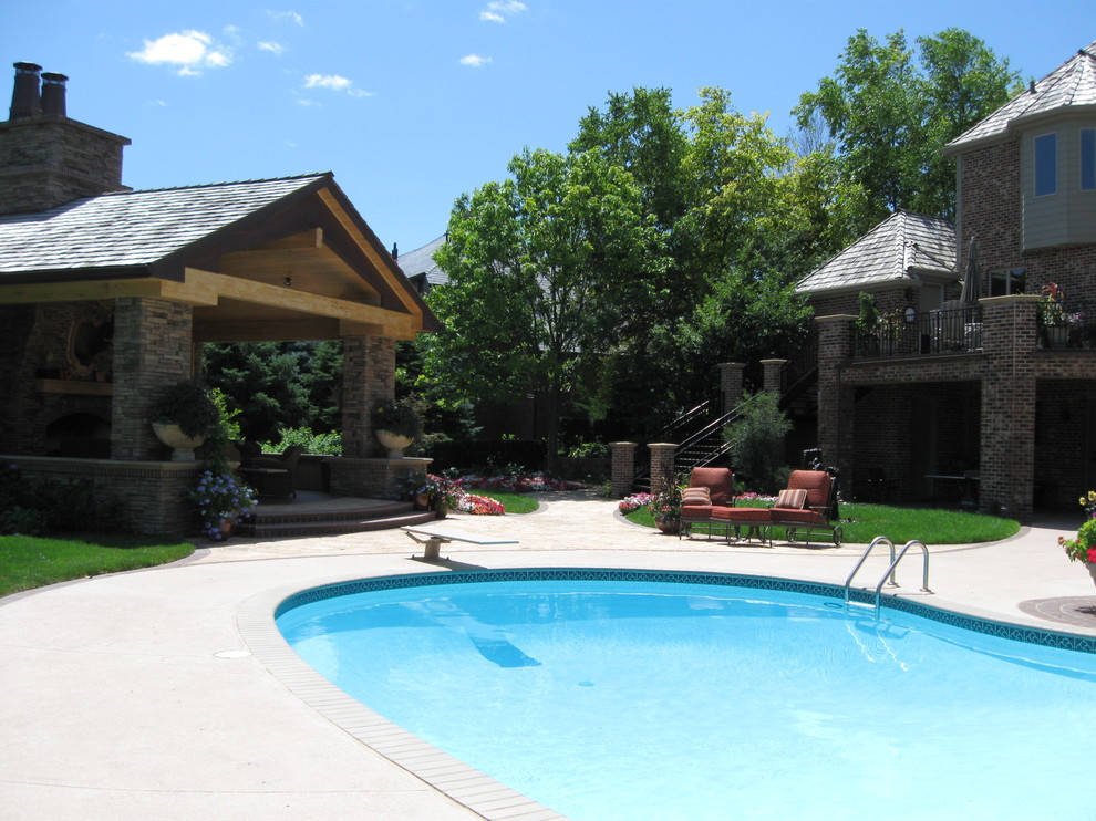 Photo of a large transitional backyard partial sun garden for summer in Omaha with natural stone pavers and with pond.