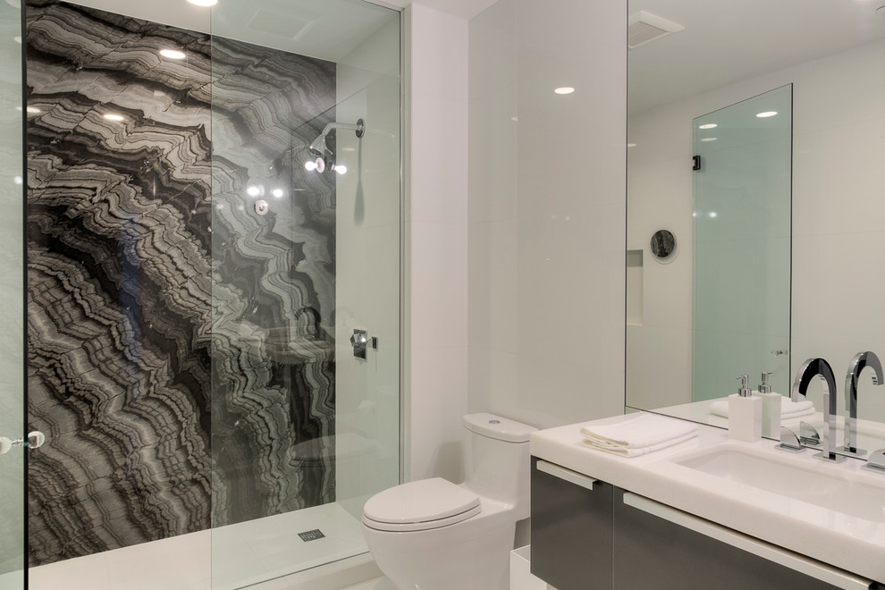 Inspiration for a contemporary bathroom in Miami with an undermount sink, quartzite benchtops, an open shower, a one-piece toilet, white tile, porcelain tile, white walls and marble floors.