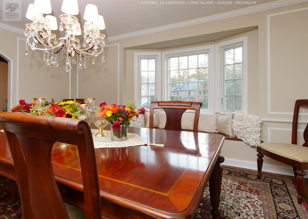 Mid-sized separate dining room in New York with beige walls, dark hardwood floors, no fireplace and multi-coloured floor.