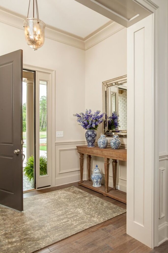 Inspiration for a mid-sized timeless medium tone wood floor foyer remodel in Wilmington with beige walls and a gray front door