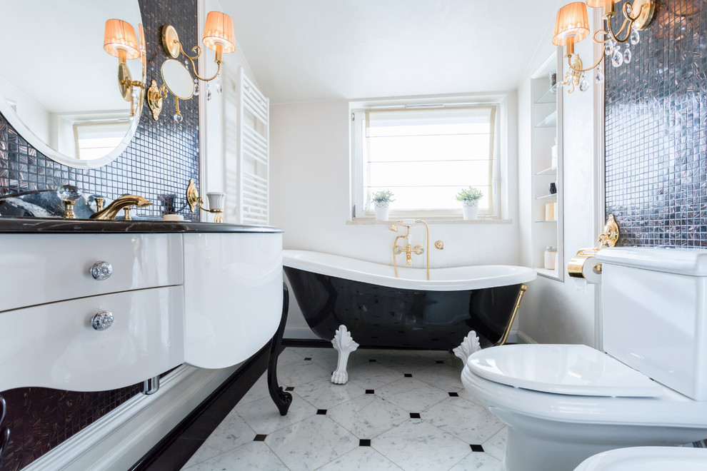 Design ideas for a small traditional bathroom in Other with mosaic tile, white walls, black and white tile, flat-panel cabinets, white cabinets, a claw-foot tub, an integrated sink, marble benchtops and a one-piece toilet.