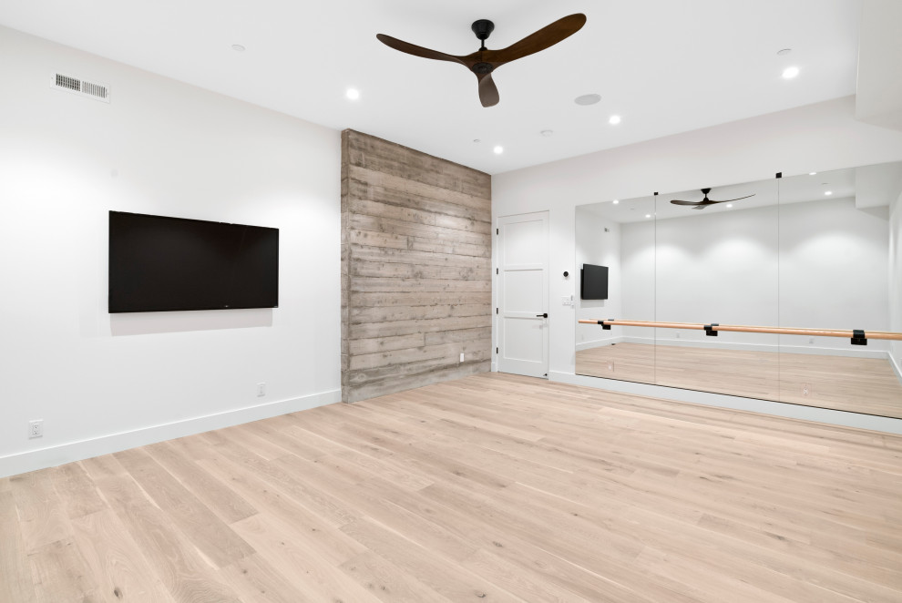 Design ideas for a large modern home gym in San Francisco with white walls, light hardwood floors and brown floor.