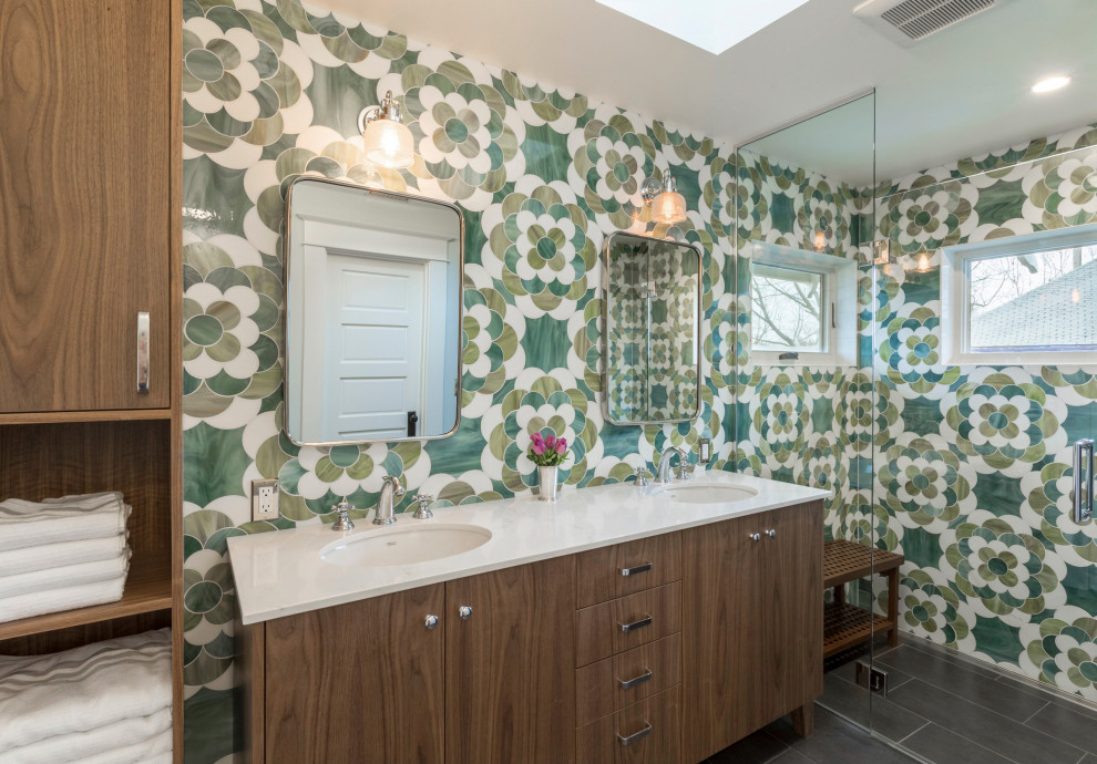 This is an example of a contemporary bathroom in Portland with flat-panel cabinets, medium wood cabinets, an alcove shower, green tile, an undermount sink, grey floor and white benchtops.
