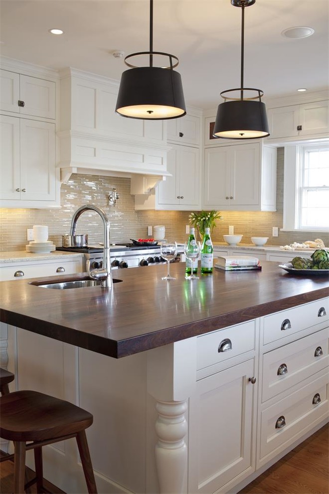 This is an example of a traditional kitchen in Other with an undermount sink, shaker cabinets, white cabinets, beige splashback, glass tile splashback, stainless steel appliances, medium hardwood floors and with island.