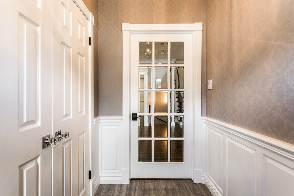 Photo of a mid-sized transitional vestibule in Montreal with porcelain floors, a single front door, a white front door and grey floor.