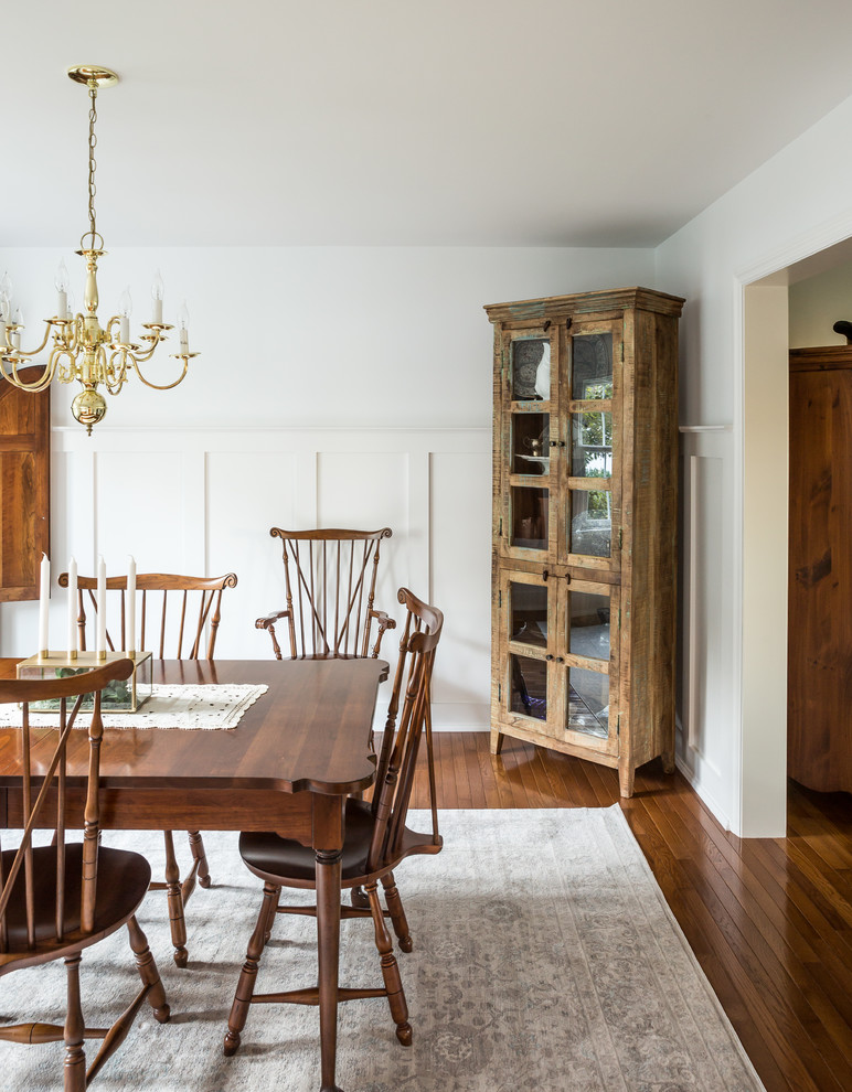 Photo of a traditional dining room in Other with white walls, medium hardwood floors and brown floor.