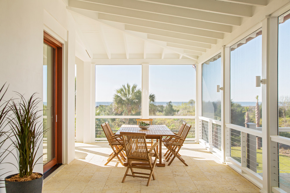 Design ideas for a beach style screened-in verandah in Charleston with tile and a roof extension.