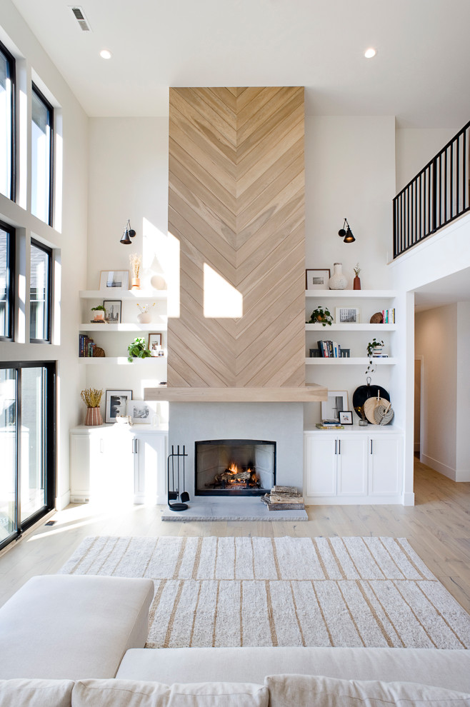 Scandinavian open concept living room in Other with a standard fireplace and a wood fireplace surround.