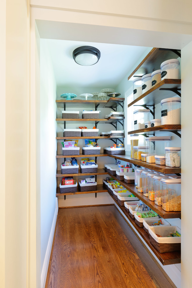 Example of a classic medium tone wood floor kitchen design in Cincinnati with a drop-in sink, raised-panel cabinets, distressed cabinets, granite countertops, subway tile backsplash, stainless steel appliances and an island