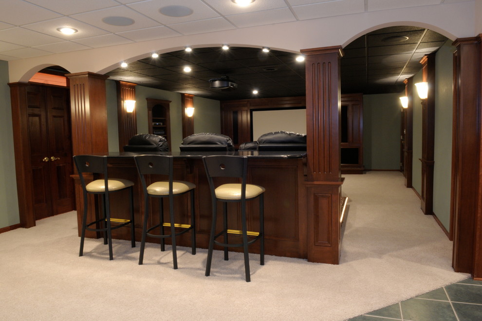 Basement - large transitional underground carpeted and beige floor basement idea with green walls and no fireplace