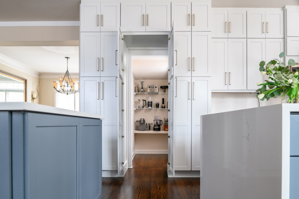 Inspiration for a large modern grey and white u-shaped kitchen pantry in Atlanta with a submerged sink, shaker cabinets, white cabinets, engineered stone countertops, grey splashback, marble splashback, stainless steel appliances, medium hardwood flooring, multiple islands, brown floors and white worktops.