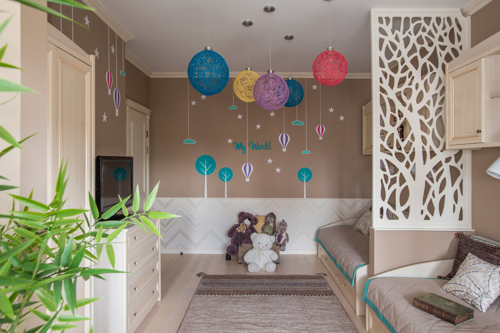Photo of a transitional gender-neutral kids' bedroom in Other with brown walls, light hardwood floors and beige floor.
