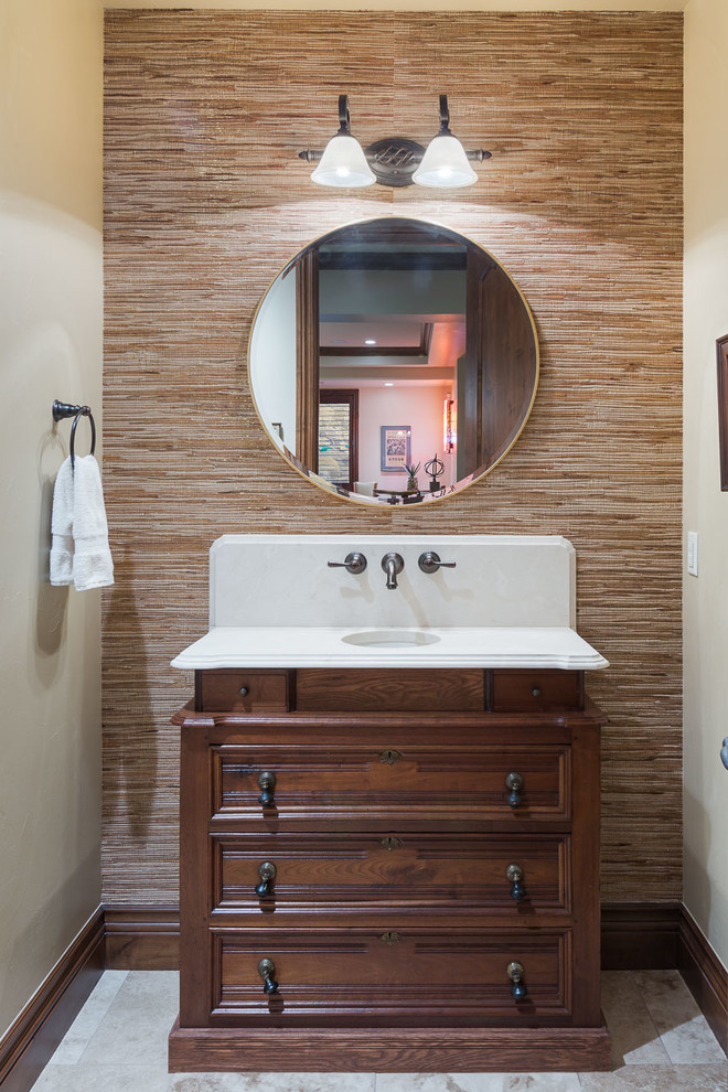 Inspiration for a small country powder room in Denver with furniture-like cabinets, dark wood cabinets, a two-piece toilet, brown walls, travertine floors, an undermount sink, engineered quartz benchtops, beige floor and white benchtops.