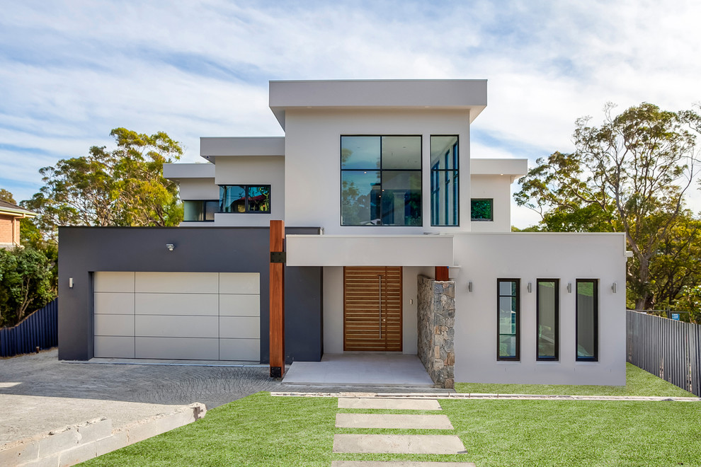 Photo of a contemporary two-storey grey house exterior in Sydney with a flat roof.
