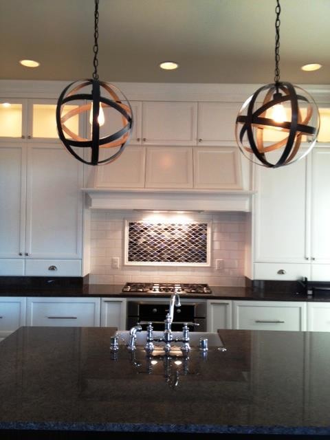 Mid-sized transitional u-shaped eat-in kitchen photo in Seattle with recessed-panel cabinets, white cabinets, granite countertops, white backsplash, subway tile backsplash, stainless steel appliances and an island