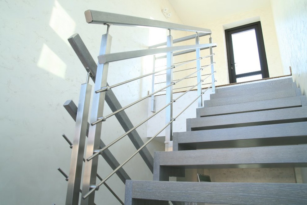 Modern metal stair covered by patina oak
