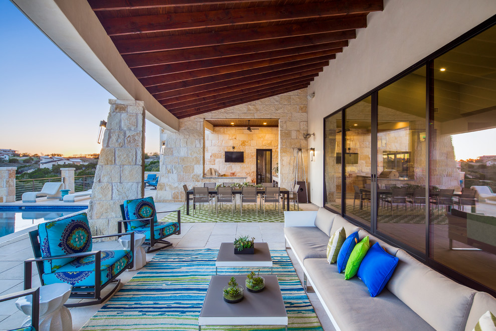 Photo of a contemporary patio in Austin with an outdoor kitchen and a roof extension.