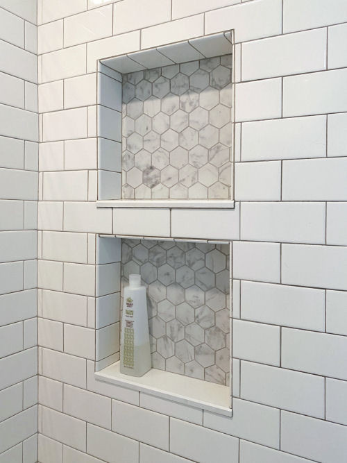 Photo of a classic ensuite bathroom in Boston with shaker cabinets, grey cabinets, an alcove bath, a shower/bath combination, a bidet, white tiles, metro tiles, white walls, porcelain flooring, a submerged sink, engineered stone worktops, grey floors, a shower curtain, grey worktops, double sinks and a built in vanity unit.