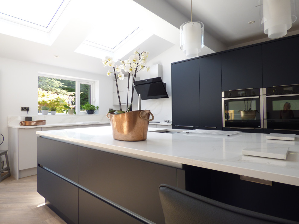 Photo of a large contemporary kitchen with flat-panel cabinets, blue cabinets, quartz worktops and white worktops.
