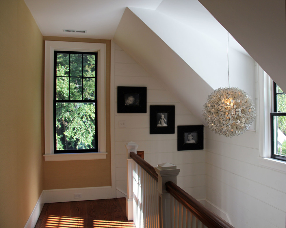 Design ideas for a small country hallway in Wilmington with beige walls and dark hardwood floors.