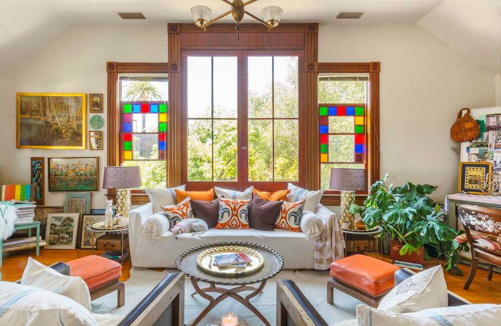 Eclectic formal and enclosed medium tone wood floor living room photo in Los Angeles with white walls