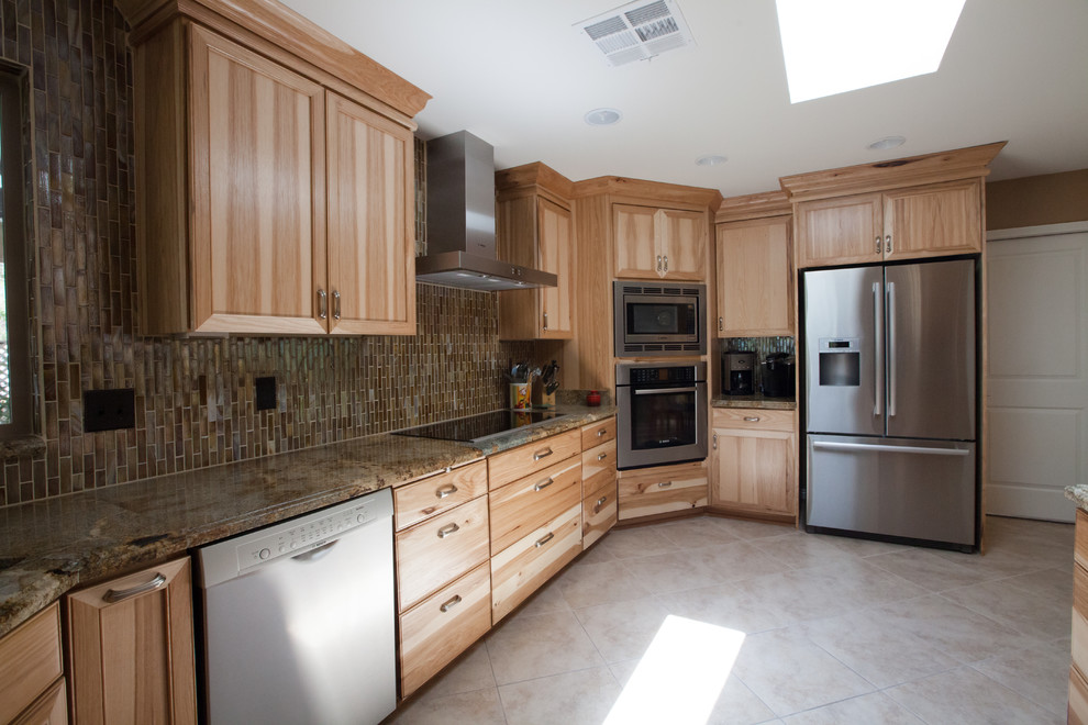 Large transitional galley ceramic tile enclosed kitchen photo in Phoenix with an undermount sink, recessed-panel cabinets, light wood cabinets, granite countertops, brown backsplash, glass tile backsplash and stainless steel appliances