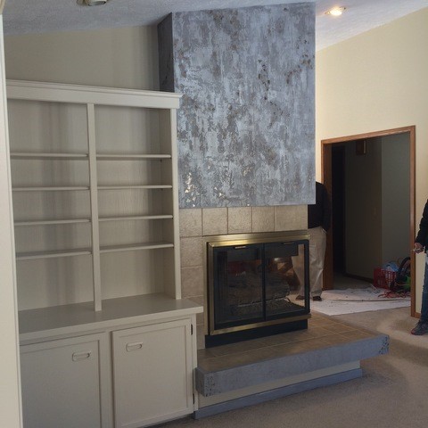 Mid-sized elegant carpeted great room photo in Grand Rapids with beige walls, a two-sided fireplace and a concrete fireplace