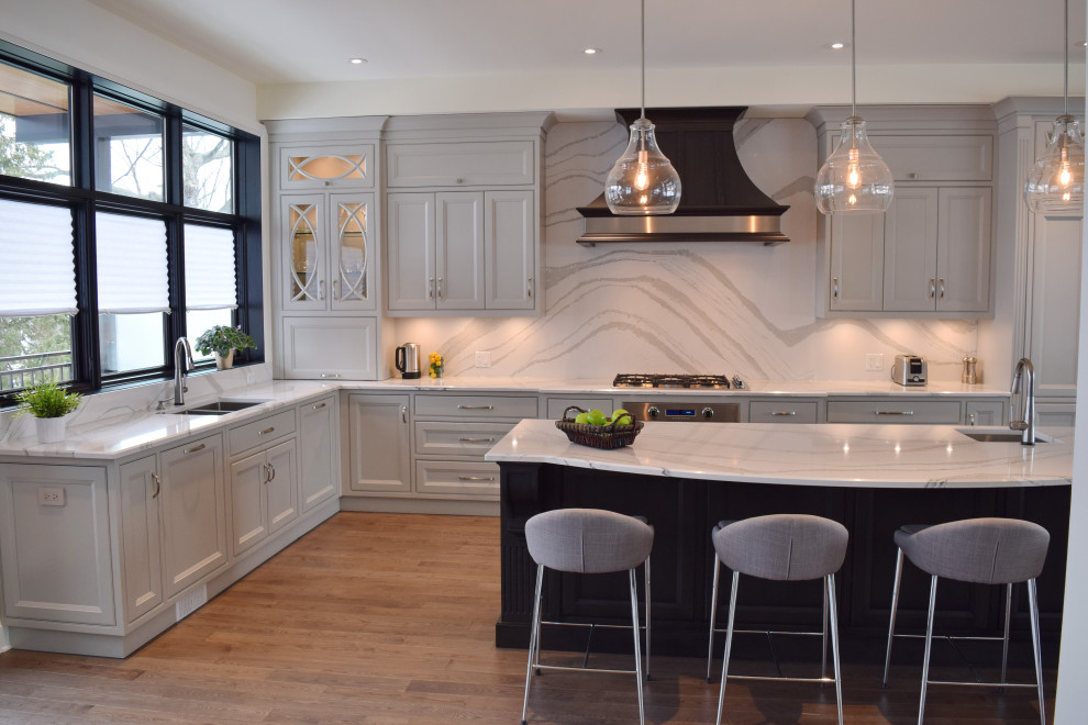 Inspiration for a large l-shaped medium tone wood floor and brown floor open concept kitchen remodel in Ottawa with an undermount sink, recessed-panel cabinets, white cabinets, quartz countertops, white backsplash, quartz backsplash, paneled appliances, an island and white countertops
