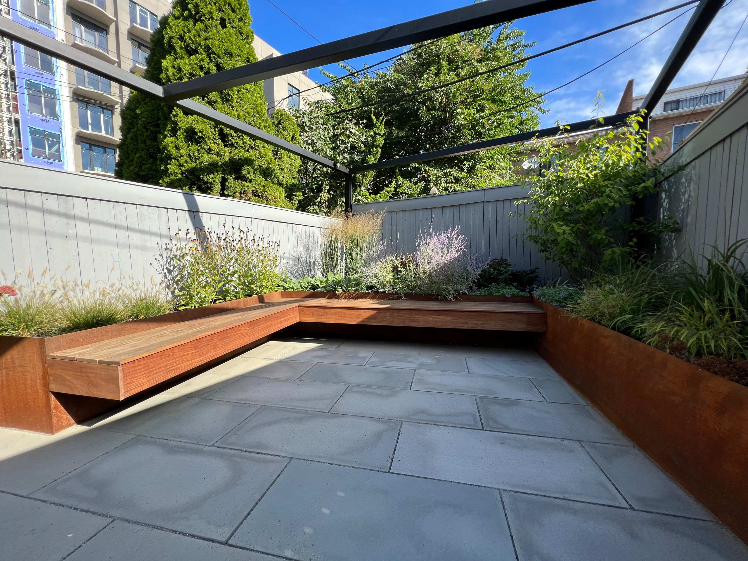 Paved patio with metal grating garden