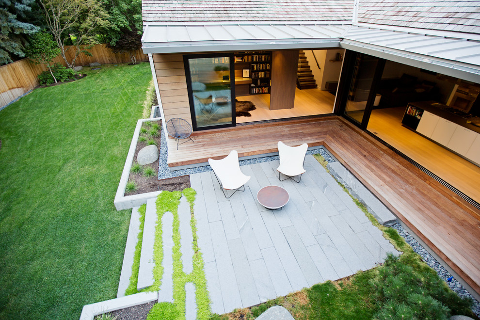 This is an example of a modern backyard patio in Salt Lake City with a roof extension.