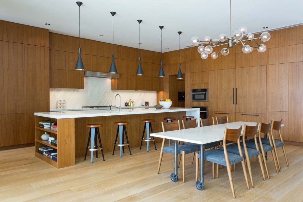 Inspiration for a contemporary eat-in kitchen with flat-panel cabinets, medium wood cabinets, white splashback, white benchtop, light hardwood floors, with island and beige floor.