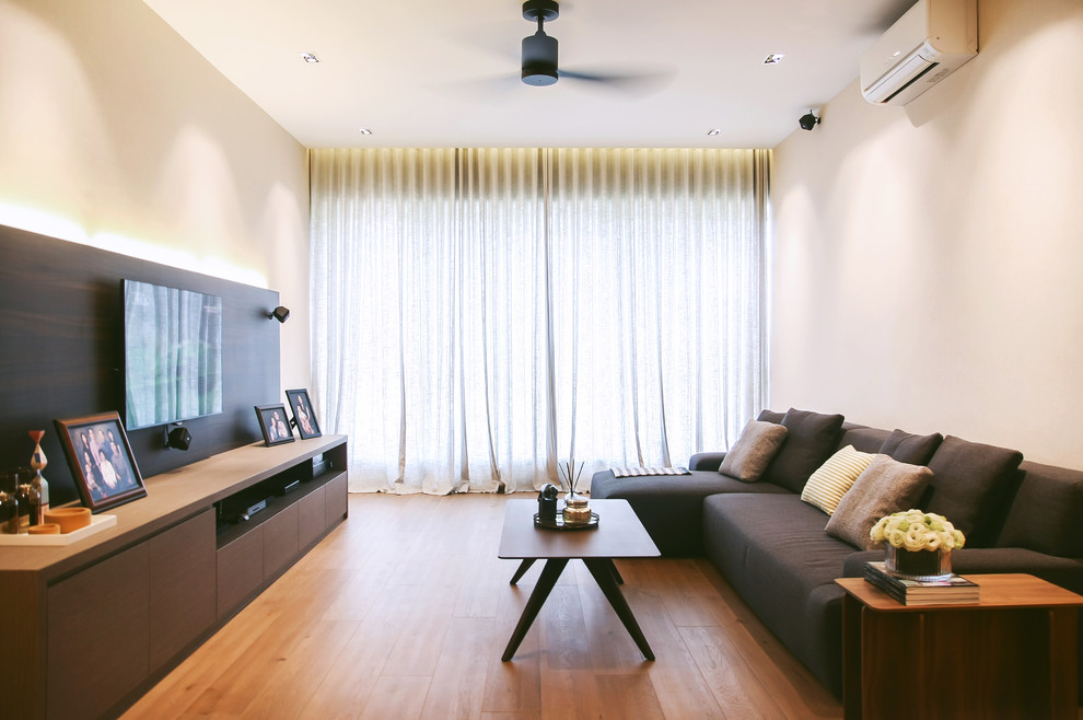 Photo of a contemporary open concept living room in Singapore with a built-in media wall.