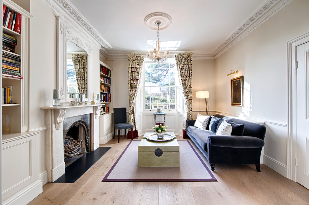 Mid-sized traditional formal open concept living room in London with light hardwood floors, a standard fireplace, a stone fireplace surround, no tv and red walls.