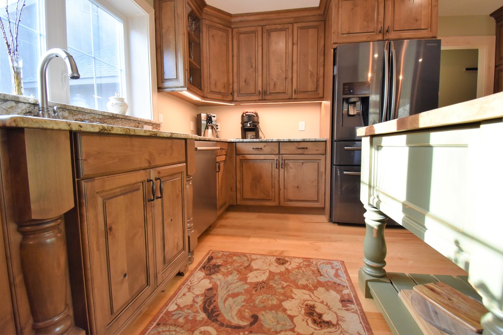 Example of a huge mountain style kitchen design with distressed cabinets