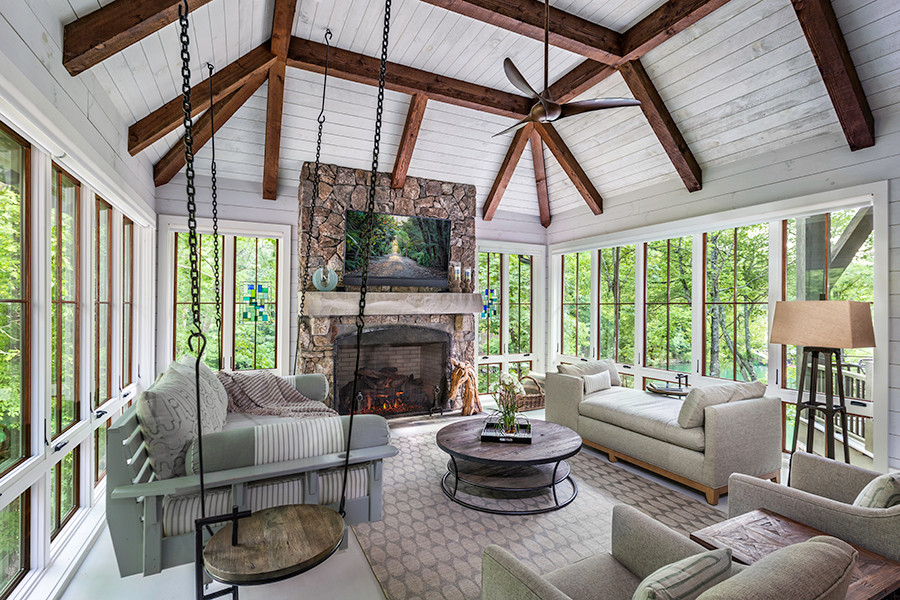 Inspiration for a large modern sunroom in Other with dark hardwood floors, a standard fireplace, a stone fireplace surround and a standard ceiling.