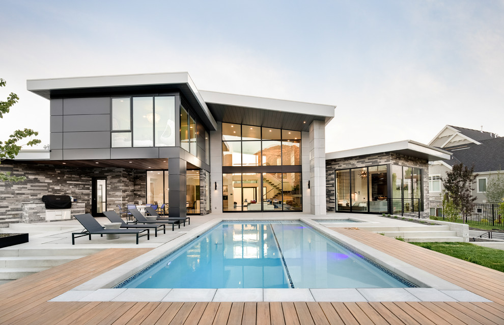Inspiration for a transitional backyard rectangular pool in Salt Lake City with a hot tub and decking.