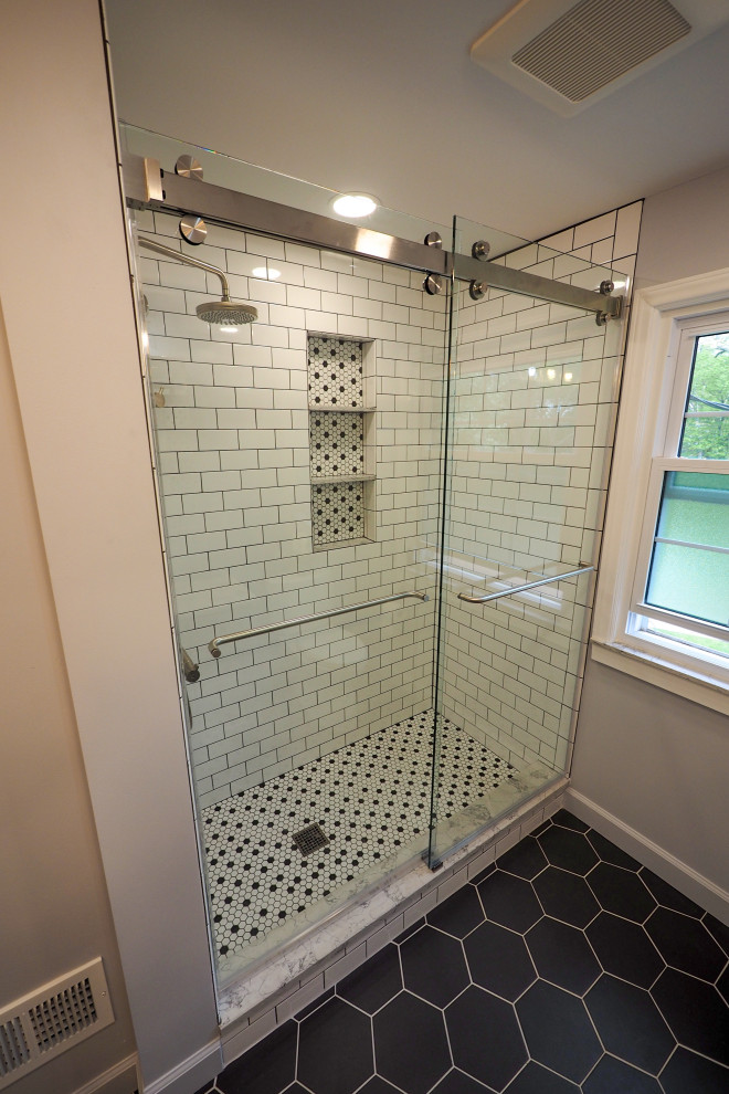 Medium sized modern bathroom in Detroit with white cabinets, a corner shower, grey walls, ceramic flooring, marble worktops, black floors, a sliding door, white worktops, double sinks and a built in vanity unit.